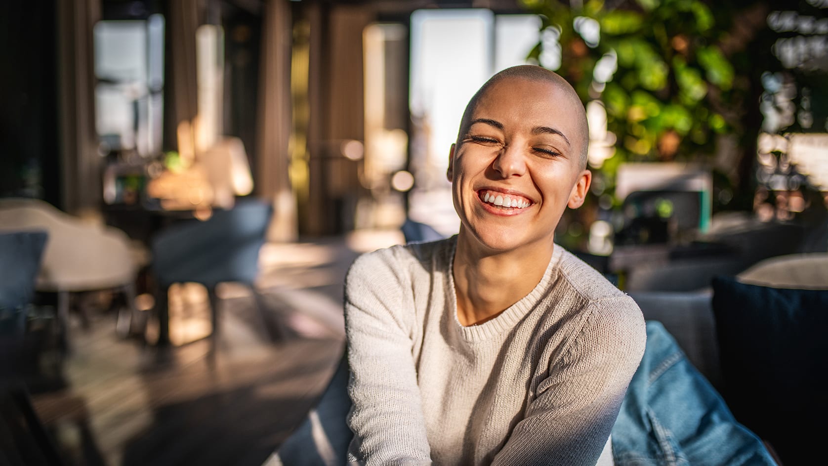 Portrait of a smiling girl with short laughing with her eyes closed